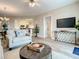 Comfortable living room area with cozy seating and entertainment center at 1 Riverwalk Dr # 202, New Smyrna Beach, FL 32169