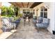 Relaxing back patio features comfortable seating and a charming pergola, perfect for outdoor enjoyment at 4606 Doris Dr, New Smyrna Beach, FL 32169