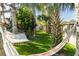 Relaxing backyard featuring palm trees and a cozy hammock at 4606 Doris Dr, New Smyrna Beach, FL 32169