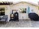 Well-maintained backyard with a paved patio, barbecue grill, and neatly arranged outdoor furniture at 4606 Doris Dr, New Smyrna Beach, FL 32169