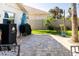 Spacious backyard with a paved patio, grill, and lush greenery, ideal for outdoor entertaining at 4606 Doris Dr, New Smyrna Beach, FL 32169