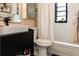 A modern bathroom vanity, toilet, bathtub with shower and window complete with black and white patterned floors at 4606 Doris Dr, New Smyrna Beach, FL 32169
