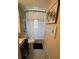 Compact bathroom features a modern vanity, a toilet, patterned floors, and a shower with a white curtain at 4606 Doris Dr, New Smyrna Beach, FL 32169