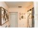 Bathroom featuring vintage mirror, sliding wood door, and coral pink walls at 4606 Doris Dr, New Smyrna Beach, FL 32169
