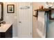 Well-lit bathroom featuring a modern vanity, creative wall decor, and a convenient towel rack at 4606 Doris Dr, New Smyrna Beach, FL 32169
