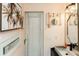 Charming bathroom with vintage decor, light pink walls and unique sliding wood door at 4606 Doris Dr, New Smyrna Beach, FL 32169