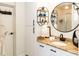 Stylish bathroom featuring a round mirror, granite countertops, and modern fixtures at 4606 Doris Dr, New Smyrna Beach, FL 32169