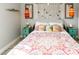Tastefully designed bedroom with beachy accents, featuring a patterned duvet and coastal decor at 4606 Doris Dr, New Smyrna Beach, FL 32169