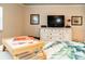 Bedroom featuring large white dresser with television and tropical style comforter at 4606 Doris Dr, New Smyrna Beach, FL 32169