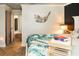 Bedroom featuring tropical comforter, wood floors and views into the hallway at 4606 Doris Dr, New Smyrna Beach, FL 32169