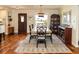 Bright dining room with a wooden table, stylish rug, and natural light, perfect for gatherings at 4606 Doris Dr, New Smyrna Beach, FL 32169