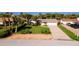 Well-manicured lawn with mature landscaping and large driveway leading to a two-car garage at 4606 Doris Dr, New Smyrna Beach, FL 32169
