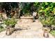 Outdoor fire pit area with paver patio and seating, landscaped with potted plants and string lights at 4606 Doris Dr, New Smyrna Beach, FL 32169