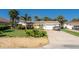 Inviting single-story home with an attached garage and well-maintained landscaping on a sunny day at 4606 Doris Dr, New Smyrna Beach, FL 32169