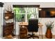 Bright home office featuring a live edge desk, tropical views and natural light at 4606 Doris Dr, New Smyrna Beach, FL 32169