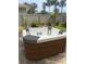 Inviting hot tub with wood-look base and gray accents surrounded by a fenced yard and palm trees at 4606 Doris Dr, New Smyrna Beach, FL 32169