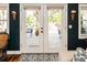 French doors open to a lovely outdoor patio, complete with a seating area and lush landscaping at 4606 Doris Dr, New Smyrna Beach, FL 32169