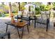 Outdoor seating area with comfortable chairs, a coffee table, and lush landscaping at 4606 Doris Dr, New Smyrna Beach, FL 32169