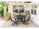 Covered patio with a tile floor, an outdoor dining set and ceiling fan at 4606 Doris Dr, New Smyrna Beach, FL 32169