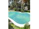 Inviting backyard pool features a unique shape and offers a relaxing outdoor retreat at 4606 Doris Dr, New Smyrna Beach, FL 32169