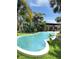 Inviting backyard pool surrounded by lush greenery, offering a perfect spot for relaxation and recreation at 4606 Doris Dr, New Smyrna Beach, FL 32169