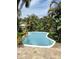 Inviting backyard pool surrounded by lush landscaping, perfect for relaxing and enjoying the outdoors at 4606 Doris Dr, New Smyrna Beach, FL 32169