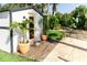 Backyard shed, surrounded by lush plants and grass, with an inviting entry and bright paint at 4606 Doris Dr, New Smyrna Beach, FL 32169