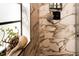 The elegant shower design with marble-style tiles is enhanced by a decorative shell pot on the window at 4606 Doris Dr, New Smyrna Beach, FL 32169
