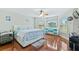 Bright bedroom with a king-size bed and wood floors at 756 Bay Dr, New Smyrna Beach, FL 32168