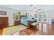 Large bedroom with wood floors and access to a patio at 756 Bay Dr, New Smyrna Beach, FL 32168