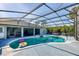 Inviting pool area with covered patio and lush landscaping at 756 Bay Dr, New Smyrna Beach, FL 32168