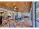 Screened-in pool patio with seating area and access to the kitchen at 756 Bay Dr, New Smyrna Beach, FL 32168