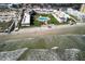 Aerial view of a beachfront condo complex featuring easy beach access and a pool with a lounge area surrounded by landscaping at 3663 S Atlantic Ave # 21C, New Smyrna Beach, FL 32169
