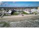 Aerial view of a beachfront condo complex with a pool and lounge area featuring lush landscaping with easy beach access at 3663 S Atlantic Ave # 21C, New Smyrna Beach, FL 32169