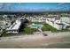 Aerial view of a beachfront condo complex with a pool and lounge area with beach access and lush landscaping at 3663 S Atlantic Ave # 21C, New Smyrna Beach, FL 32169