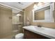 Bathroom with glass shower door and updated vanity at 3663 S Atlantic Ave # 21C, New Smyrna Beach, FL 32169