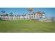 View of the exterior of the complex and the community yard space at 3663 S Atlantic Ave # 21C, New Smyrna Beach, FL 32169