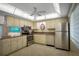 Efficient kitchen featuring stainless steel appliances, tile flooring and ample cabinet storage at 3663 S Atlantic Ave # 21C, New Smyrna Beach, FL 32169