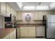 Cozy kitchen with stainless steel appliances, ample cabinetry, and a decorative clock adds a touch of charm at 3663 S Atlantic Ave # 21C, New Smyrna Beach, FL 32169
