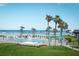 Relaxing pool area with ocean views, palm trees, lounge chairs and beach access at 3663 S Atlantic Ave # 21C, New Smyrna Beach, FL 32169