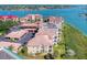 Aerial view of waterfront condo building with parking and boat slips at 434 Bouchelle Dr # 304, New Smyrna Beach, FL 32169