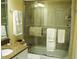 Bathroom featuring a granite vanity top, shower/tub combination and neutral tile at 434 Bouchelle Dr # 304, New Smyrna Beach, FL 32169