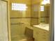 Modern bathroom with glass enclosed shower, seat, and double sink vanity at 434 Bouchelle Dr # 304, New Smyrna Beach, FL 32169