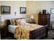 Comfortable bedroom with wood furnishings and colorful floral bedding at 434 Bouchelle Dr # 304, New Smyrna Beach, FL 32169