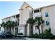 Beautiful condo building featuring stucco facade, red tile roof and well maintained landscaping at 434 Bouchelle Dr # 304, New Smyrna Beach, FL 32169
