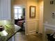 Hallway view to bedroom showcasing nice tile flooring and trim work throughout at 434 Bouchelle Dr # 304, New Smyrna Beach, FL 32169