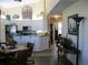 Open kitchen with white cabinets, granite counters and a large pantry at 434 Bouchelle Dr # 304, New Smyrna Beach, FL 32169