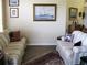 Comfortable living room featuring striped sofas and nautical-themed artwork at 434 Bouchelle Dr # 304, New Smyrna Beach, FL 32169