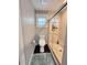 Modern bathroom featuring a glass-enclosed shower, toilet, light gray walls, and a small window at 1312 2Nd St, Edgewater, FL 32132