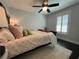 Comfortable bedroom featuring neutral walls, ceiling fan, plush pillows, and warm lighting for a restful ambiance at 1312 2Nd St, Edgewater, FL 32132